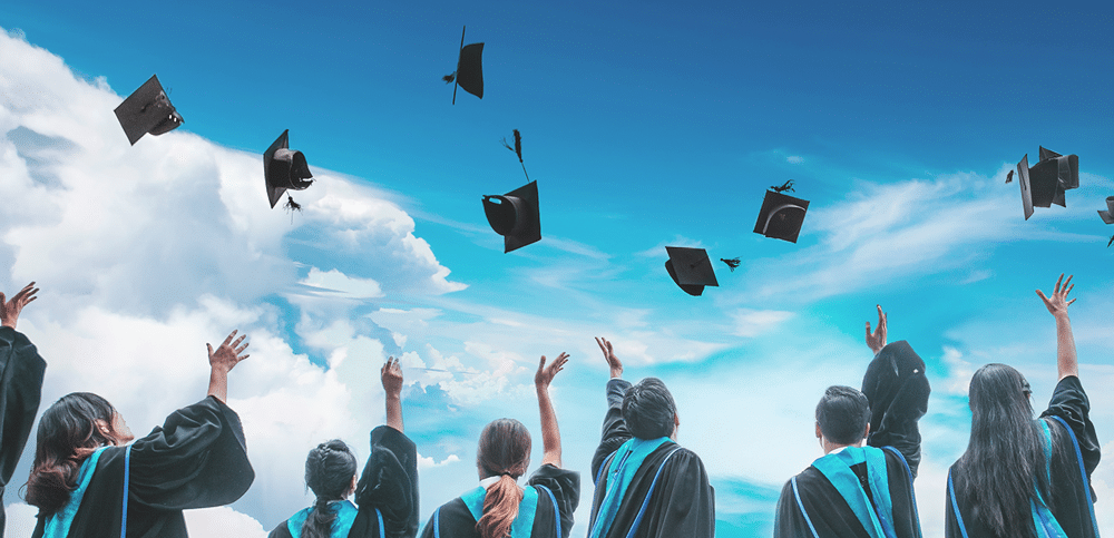 Student graduating, throwing hats